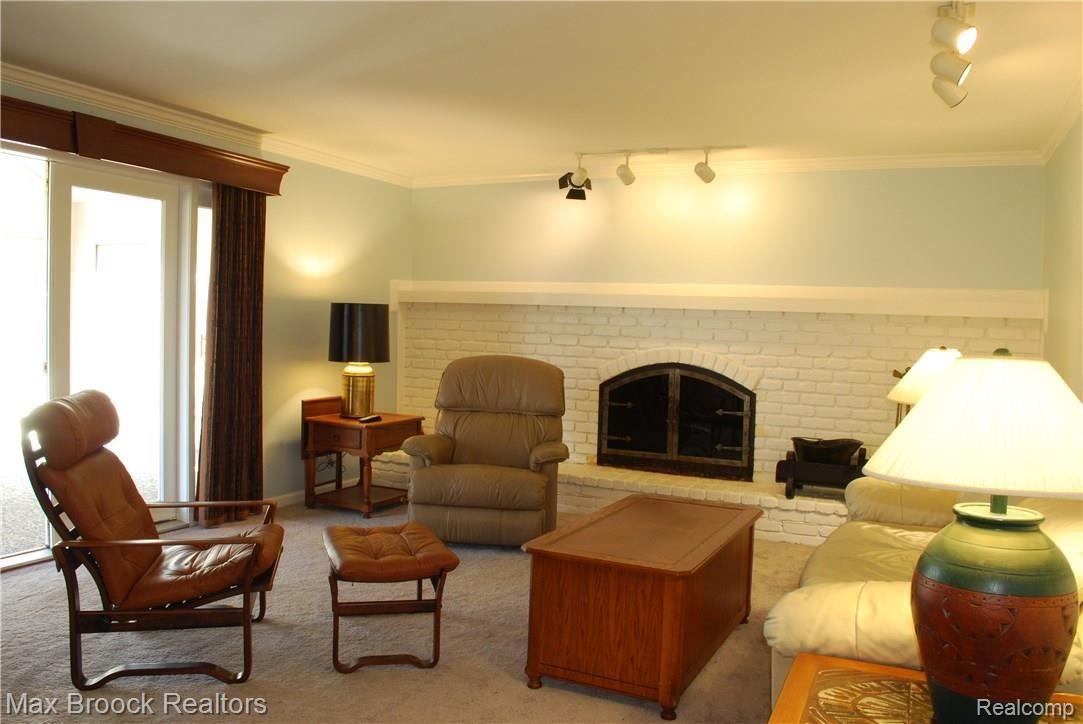 1338 Chestnut Circle Rochester, MI 48309 - Photo 17 of 69 Family room with fireplace opening to sunroom