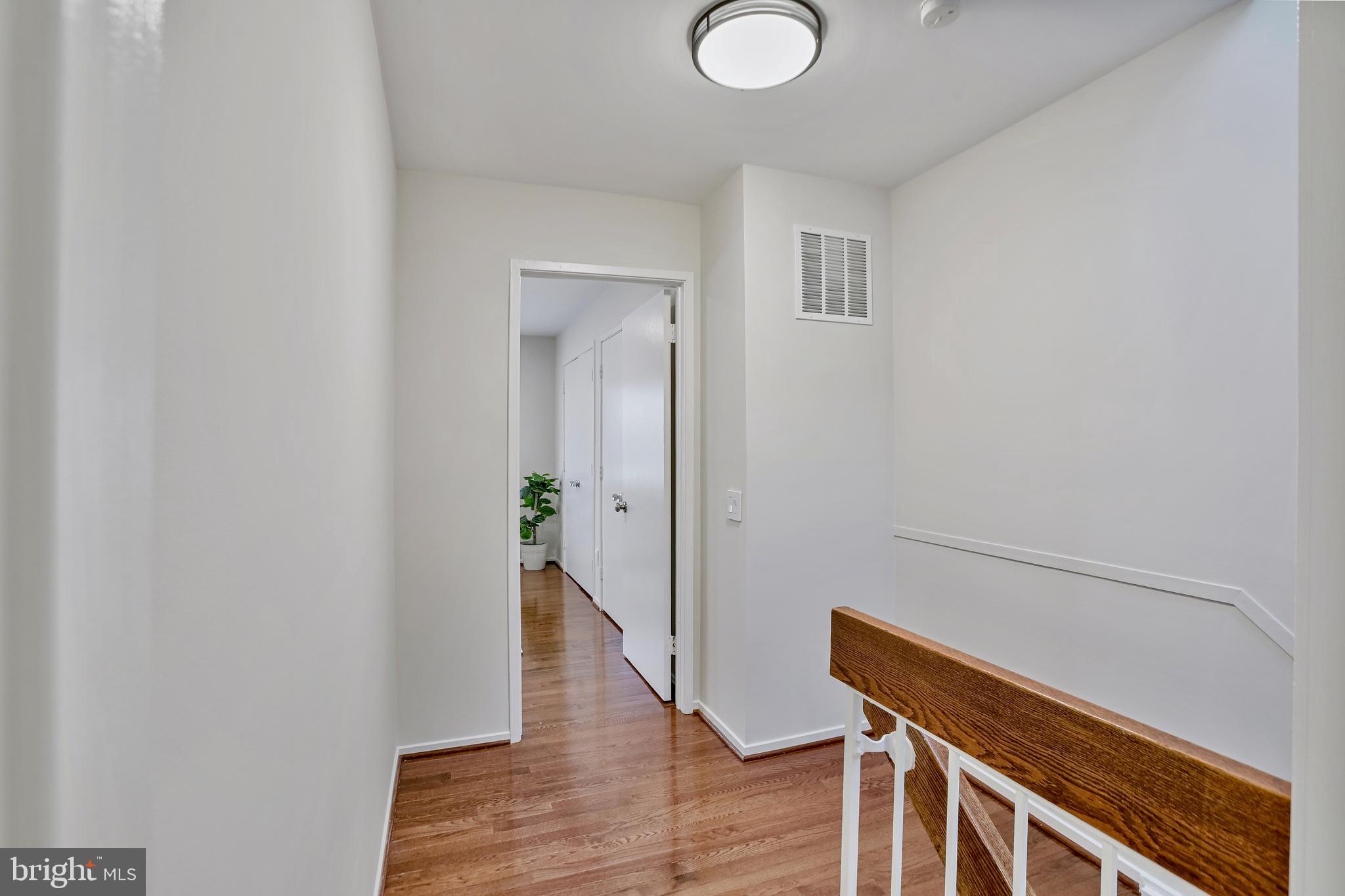 2257 Wheelwright Court Reston, VA 20191 - Photo 17 of 40 a view of a hallway with wooden floor