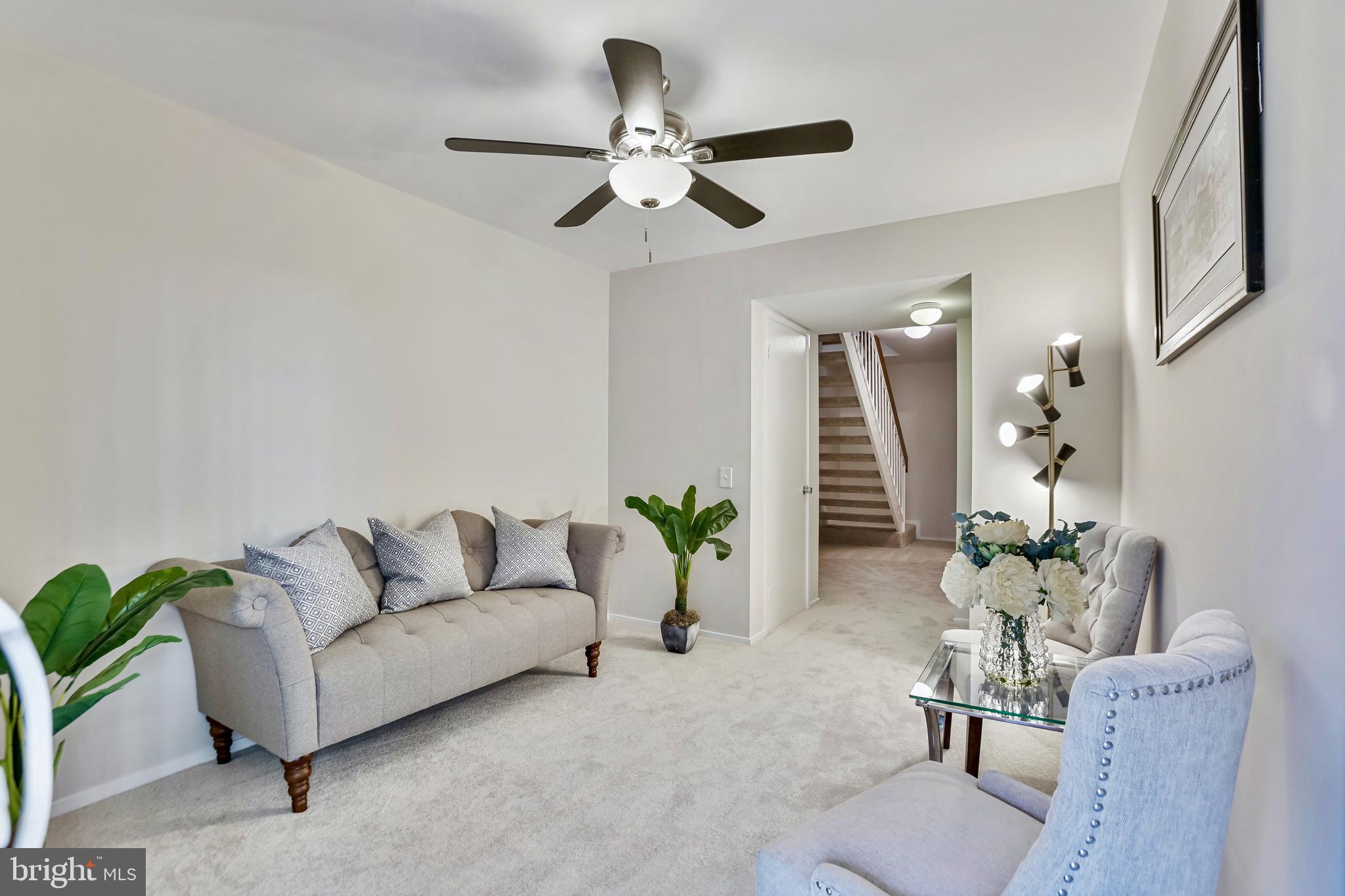 2257 Wheelwright Court Reston, VA 20191 - Photo 30 of 40 a living room with furniture and a chandelier