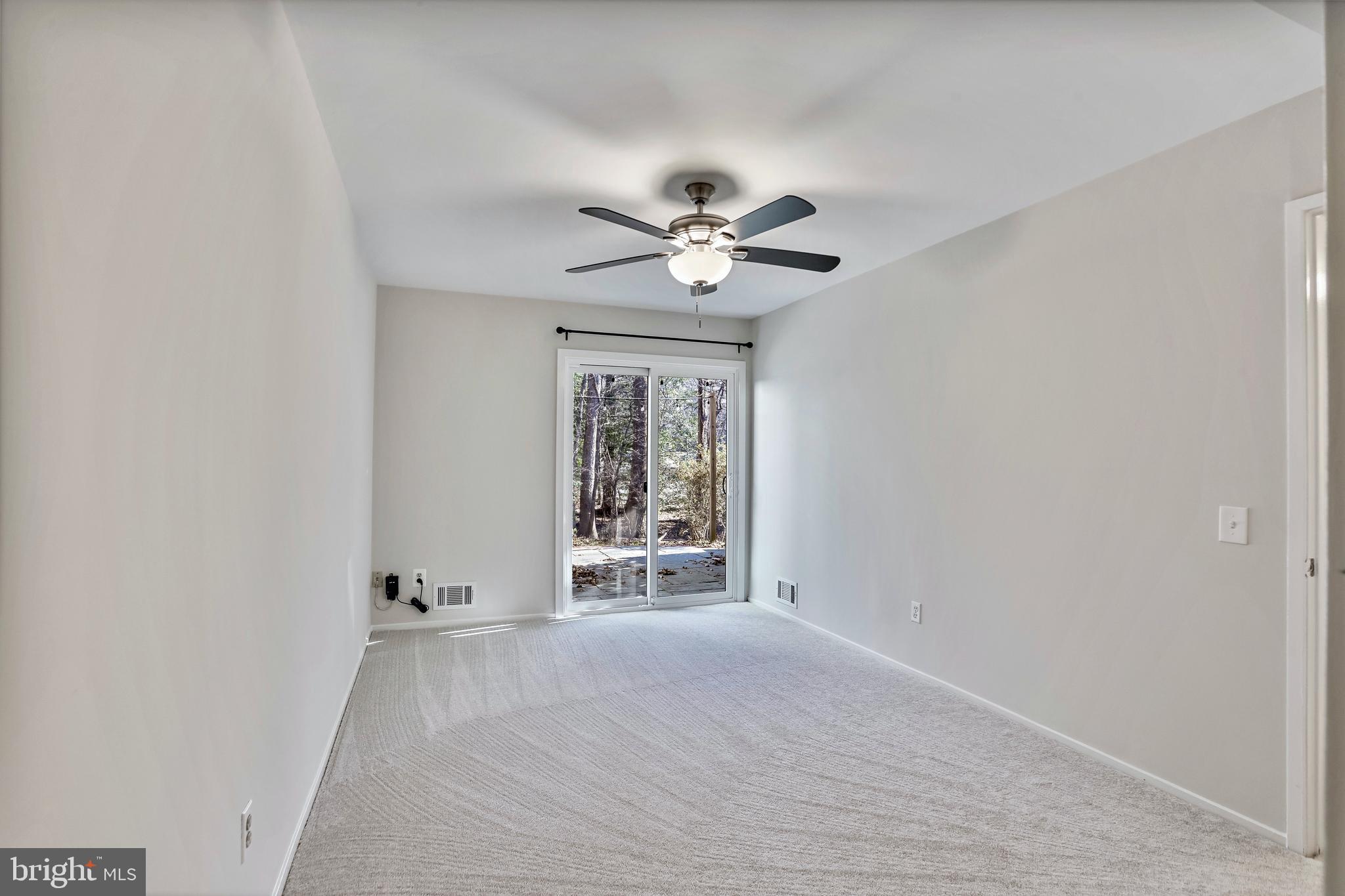 2257 Wheelwright Court Reston, VA 20191 - Photo 31 of 40 an empty room with chandelier fan and windows