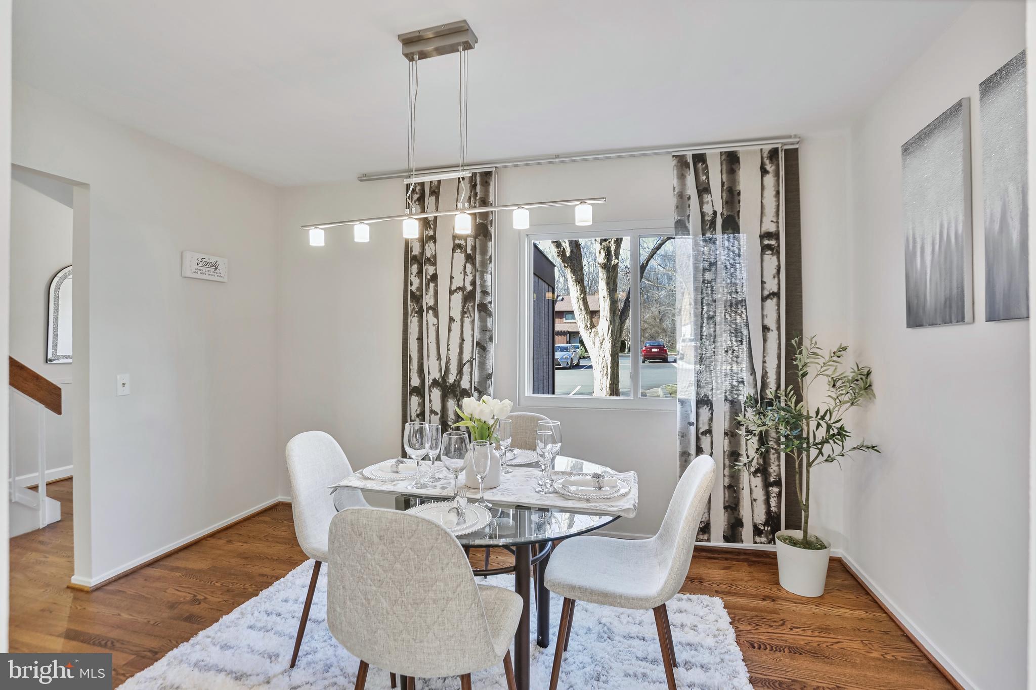 2257 Wheelwright Court Reston, VA 20191 - Photo 4 of 40 a view of a dining room with furniture and chandelier