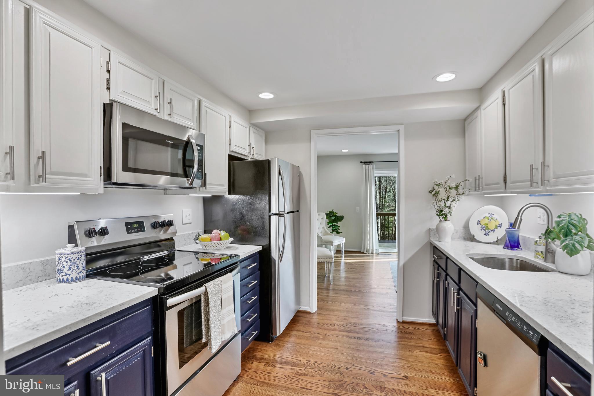 2257 Wheelwright Court Reston, VA 20191 - Photo 8 of 40 a kitchen with stainless steel appliances granite countertop a refrigerator stove microwave and sink