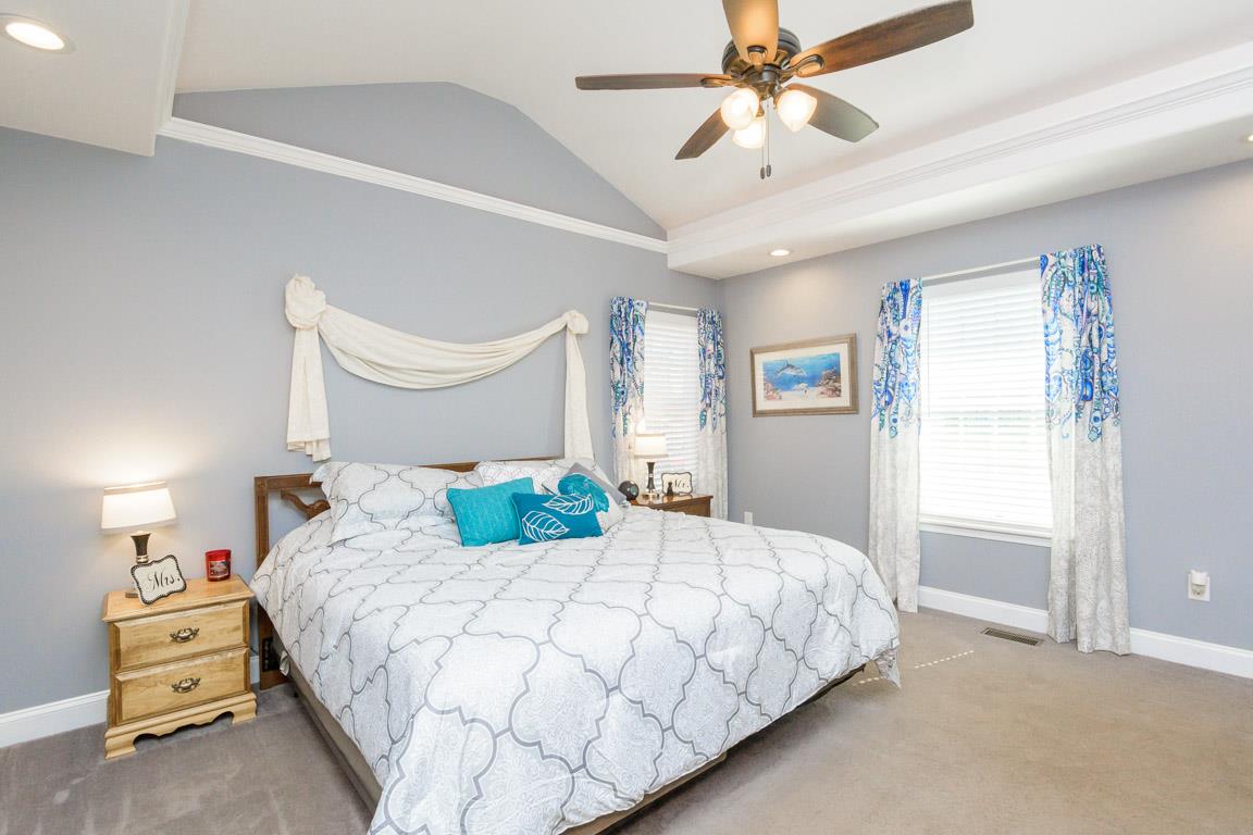 457 Goshen Road Lebanon, TN 37087 - Photo 16 of 30 a bedroom with a bed and a chandelier