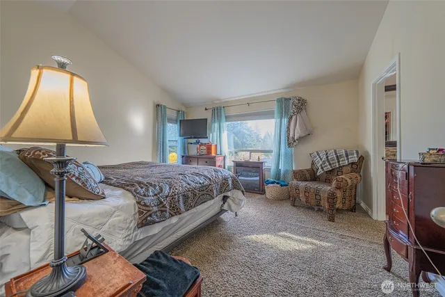 a bedroom with a bed and lamp