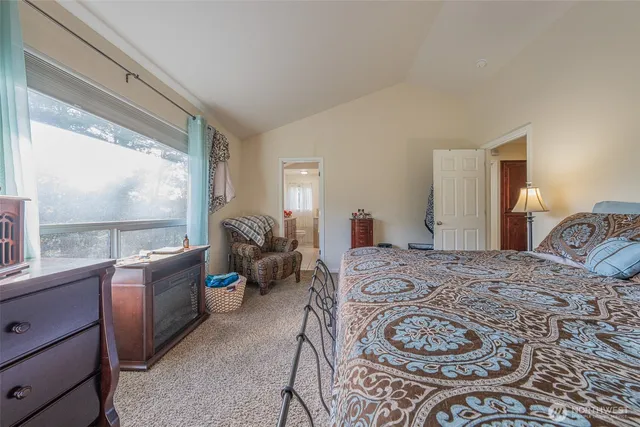 a bed room with a bed and a large window