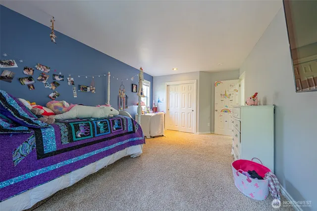 a bedroom with furniture and a dresser