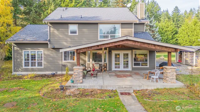 a front view of a house with swimming pool and glass windows