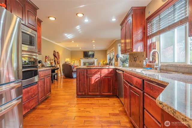 a large kitchen with stainless steel appliances lots of counter top space