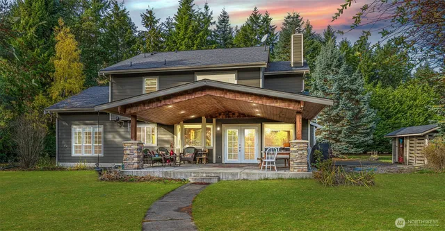a view of a house with a garden and patio
