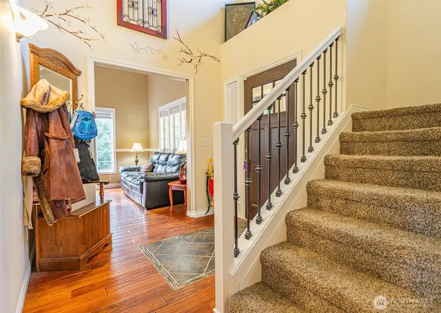 a view of entryway livingroom and hall with wooden floor