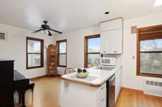 a kitchen with stainless steel appliances a sink and a refrigerator