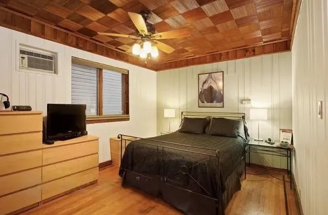 a bedroom with a bed and a flat screen tv