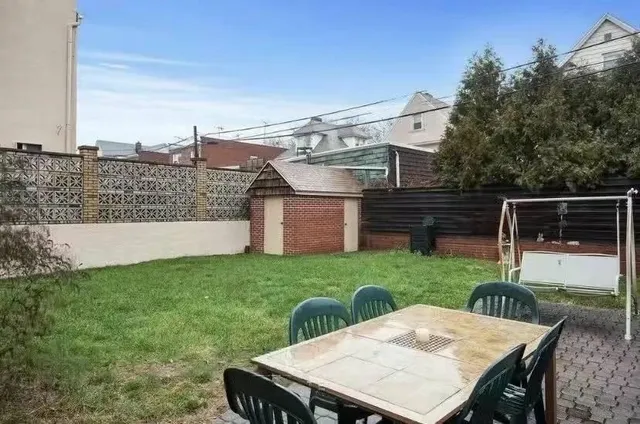 a view of a patio with table and chairs with wooden fence and plants