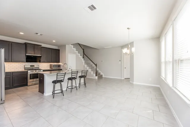 a view of kitchen with microwave and cabinets