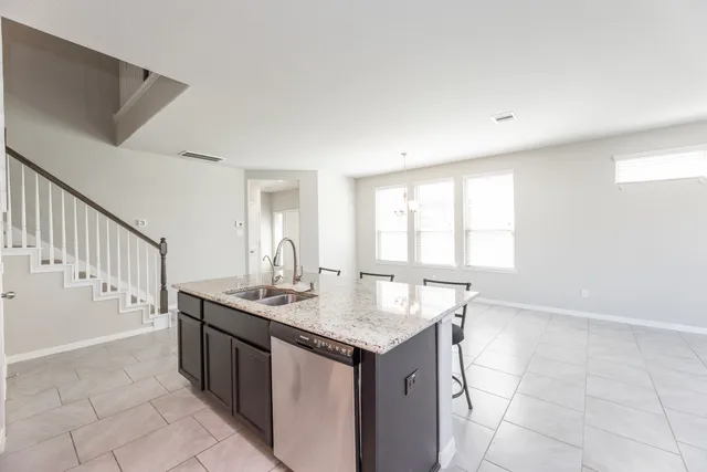 a kitchen with a sink cabinets and window