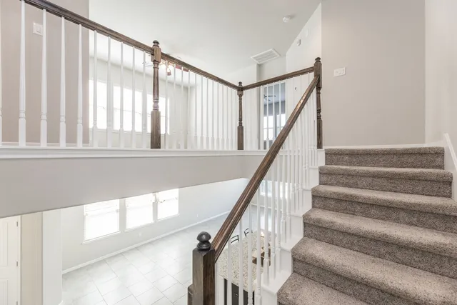 a view of staircase with white walls and a window