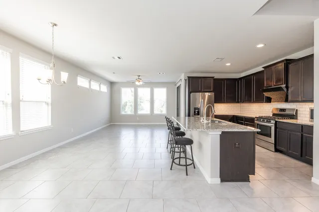 a kitchen with refrigerator and cabinets