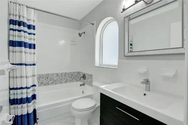 a bathroom with a bathtub a sink and a shower