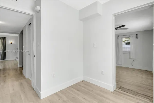a view of a hallway with wooden floor