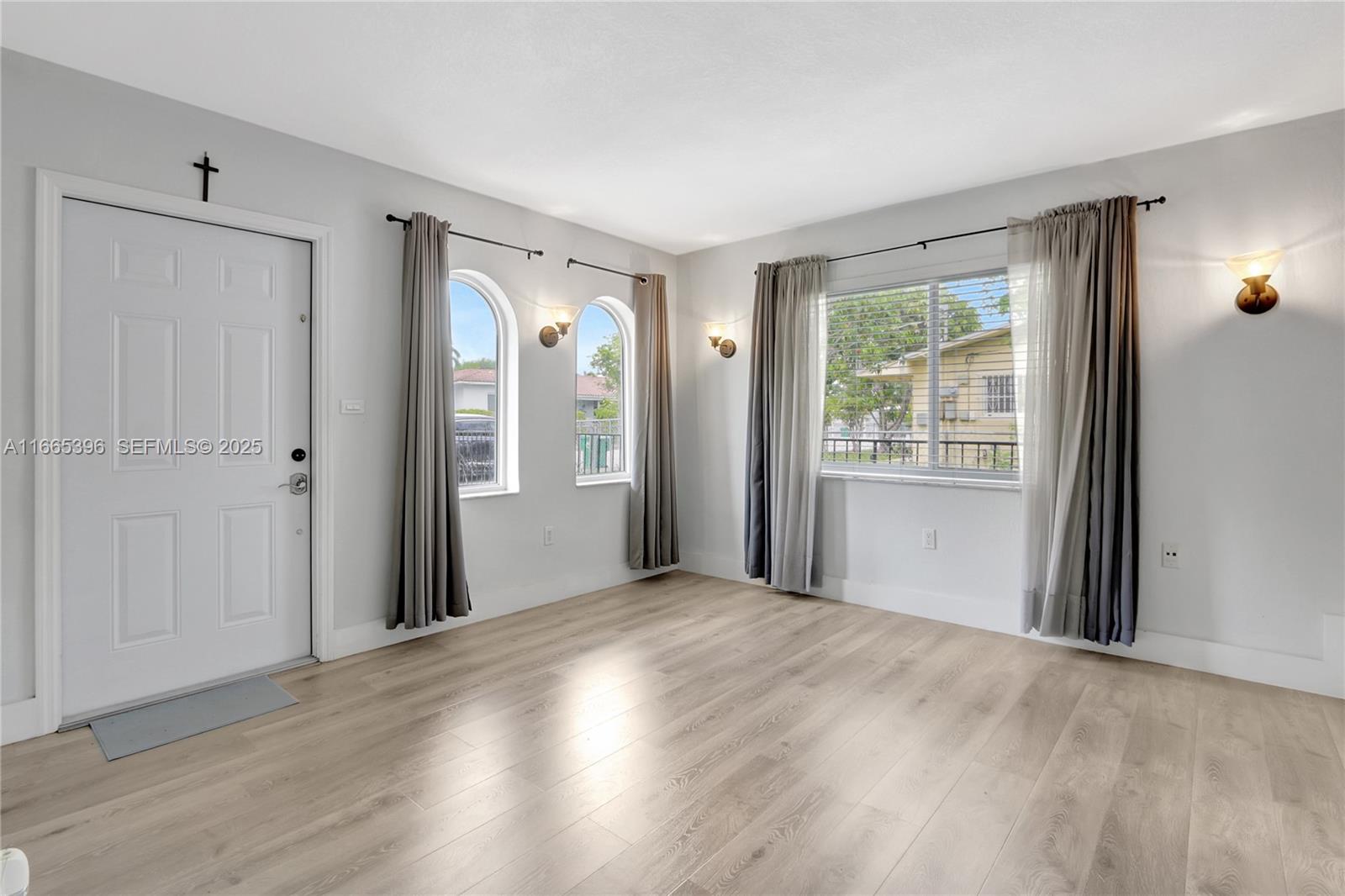 1359 Southwest 11th Street Miami, FL 33135 - Photo 23 of 25 a view of a room with wooden floor and windows
