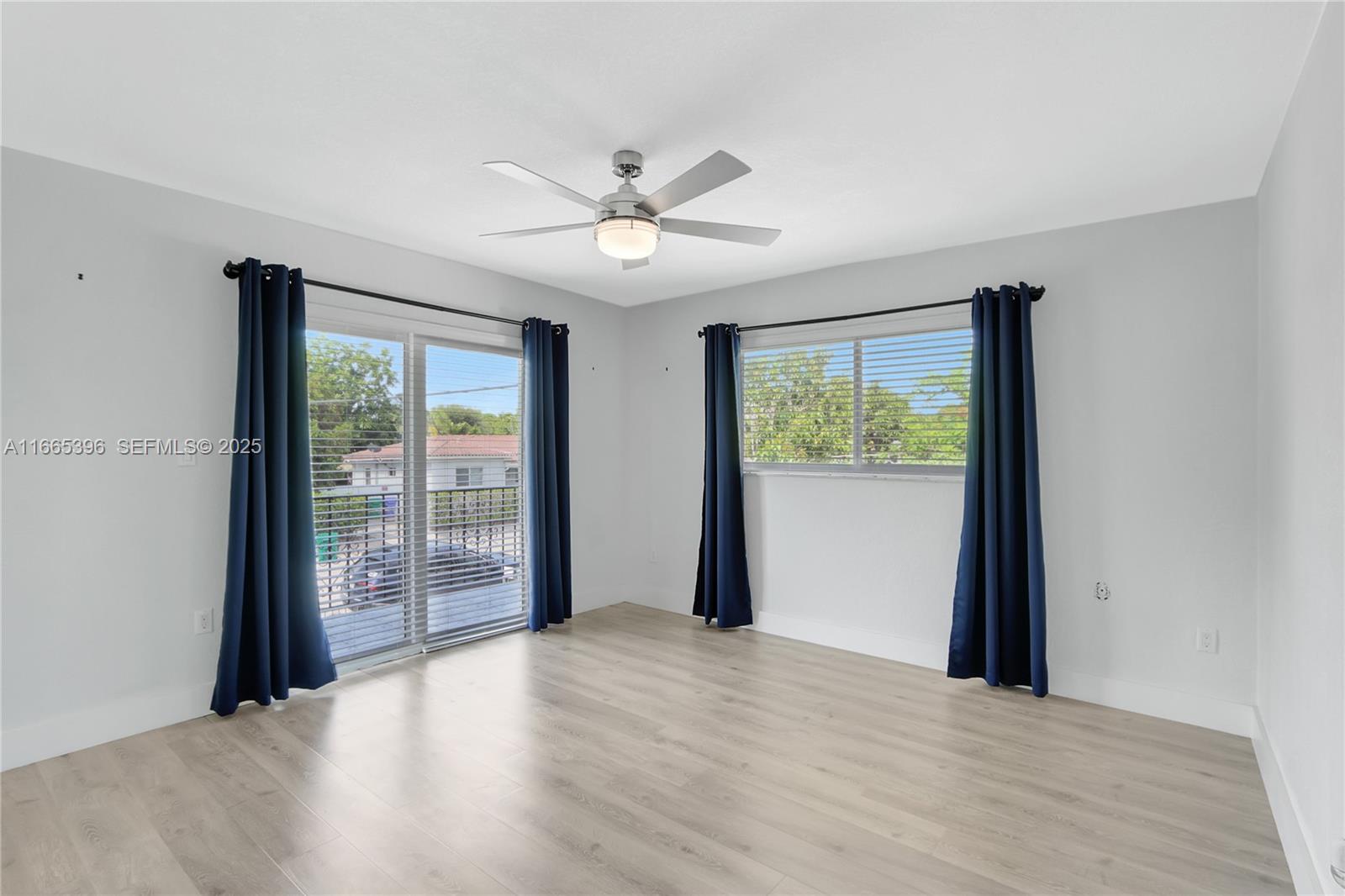 1359 Southwest 11th Street Miami, FL 33135 - Photo 5 of 25 wooden floor in an empty room with a window