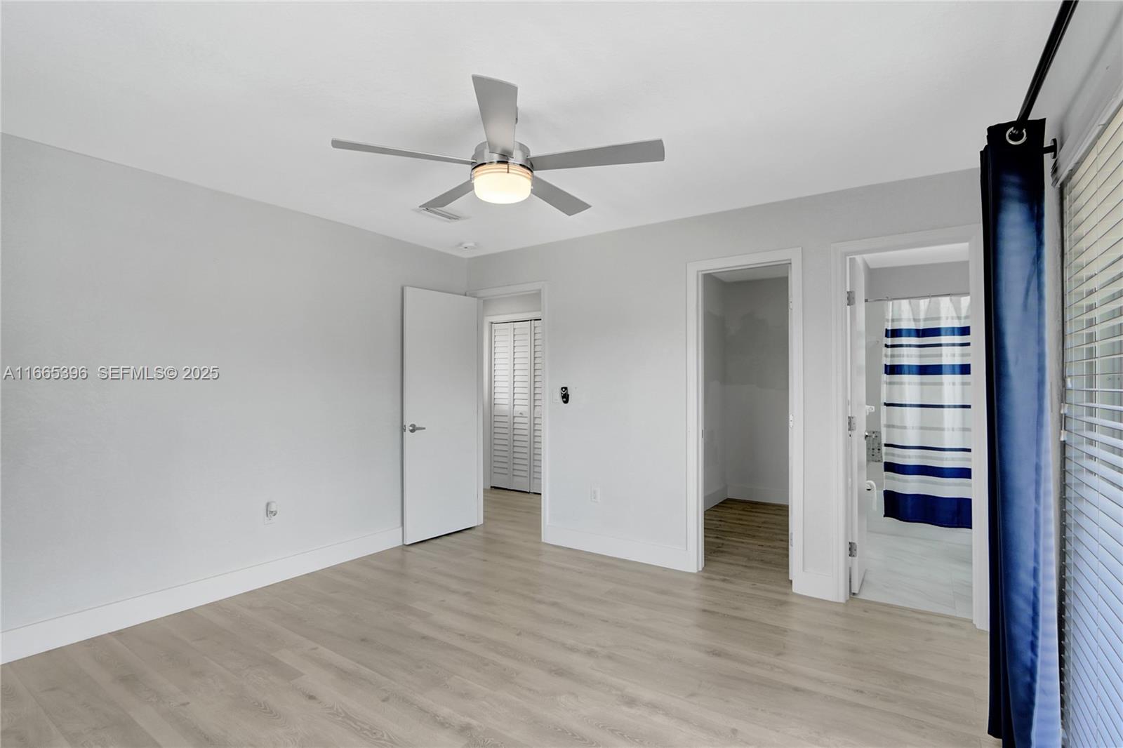 1359 Southwest 11th Street Miami, FL 33135 - Photo 6 of 25 wooden floor in an empty room with a window