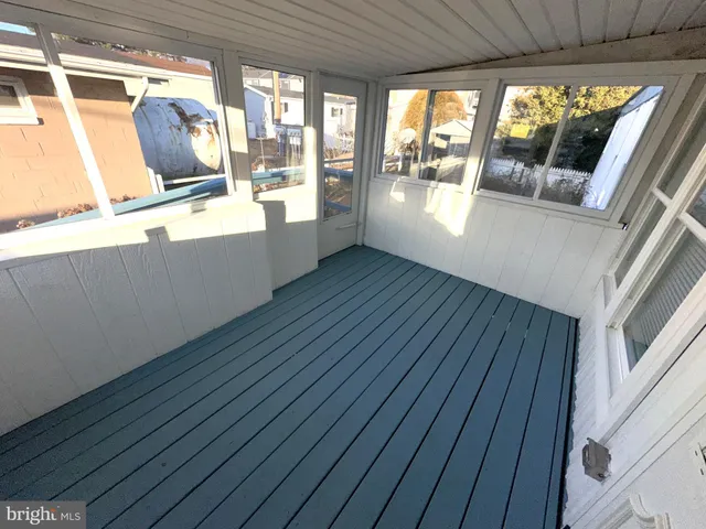 a view of a room with wooden floor and furniture