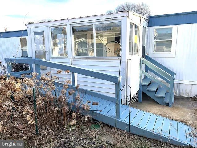 a view of a house with a balcony and wooden floor