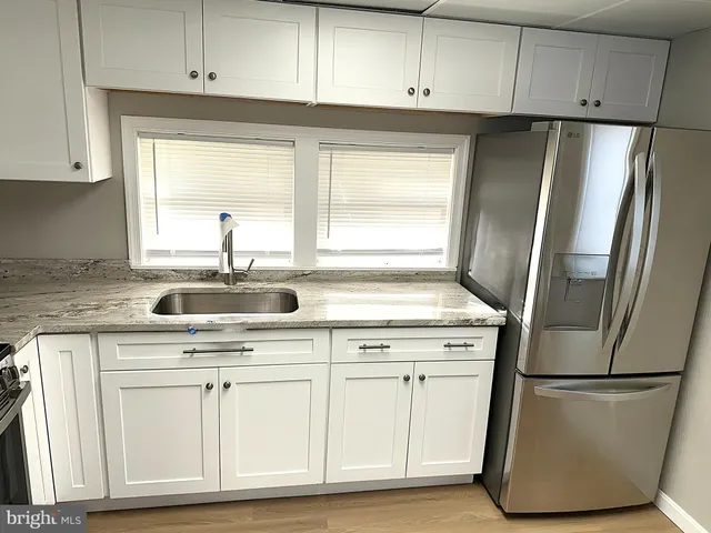 a kitchen with appliances cabinets and a sink