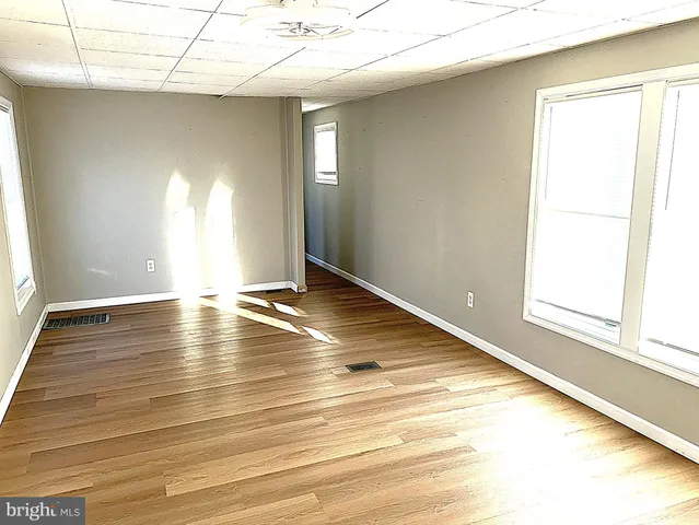 a view of room with window and wooden floor