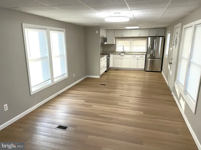 a view of a kitchen with a stove cabinets and wooden floor