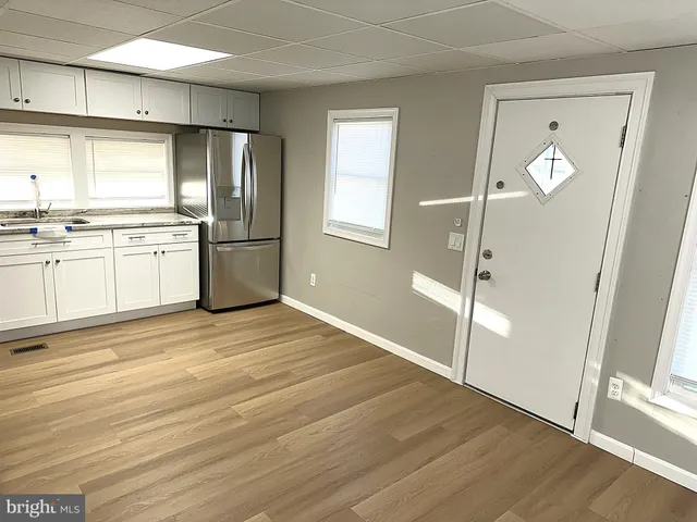 a kitchen with a refrigerator and a sink