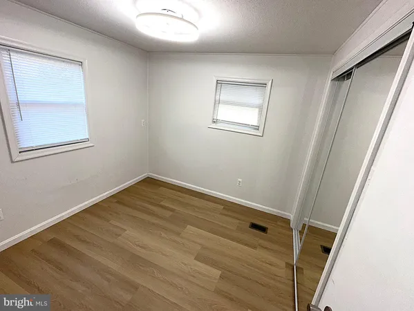 a view of room with window and hardwood floor