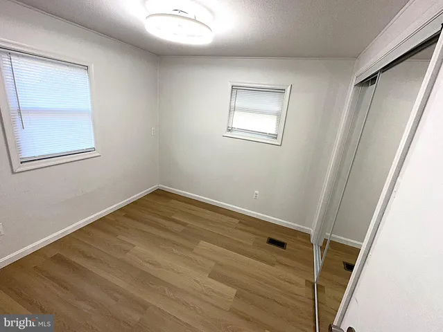 a view of room with window and hardwood floor