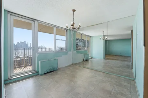 en empty room with large windows