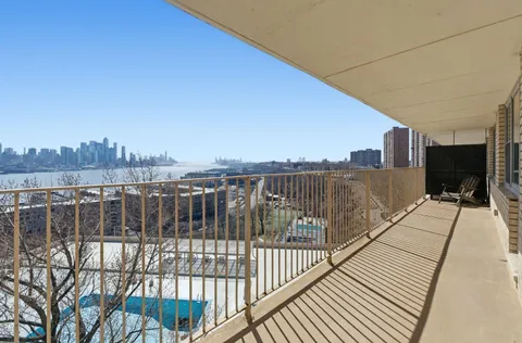 a view of a balcony with wooden floor