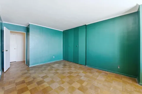a dining room with furniture and a potted plant