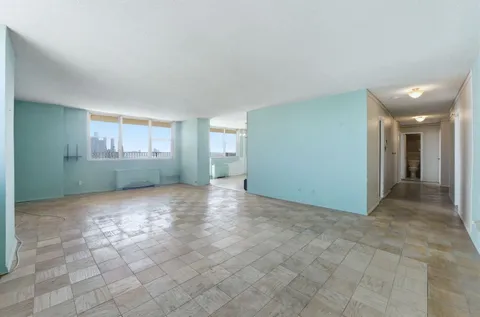 an empty room with a kitchen