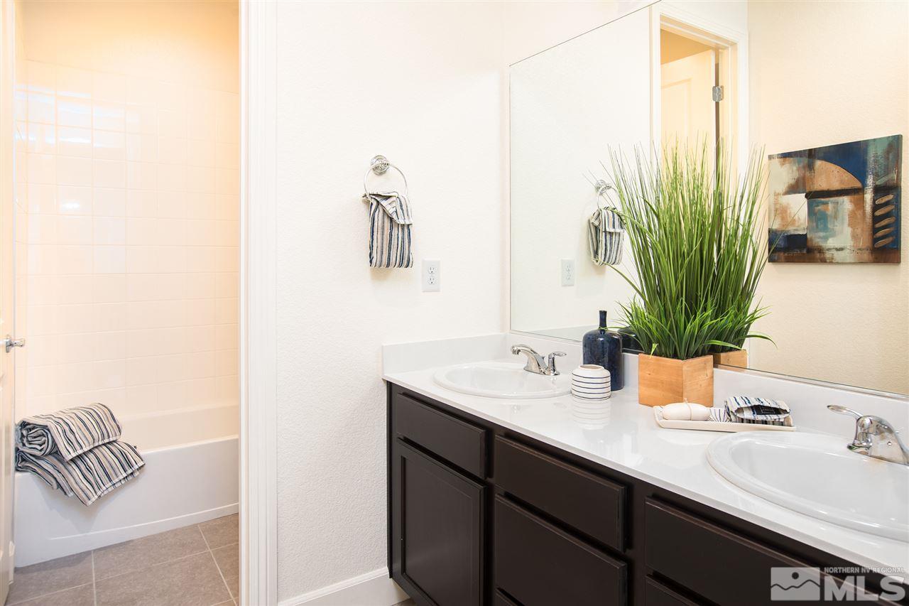 3115 Show Jumper Lane Reno, NV 89521 - Photo 15 of 25 a bathroom with a sink a mirror and a potted plant