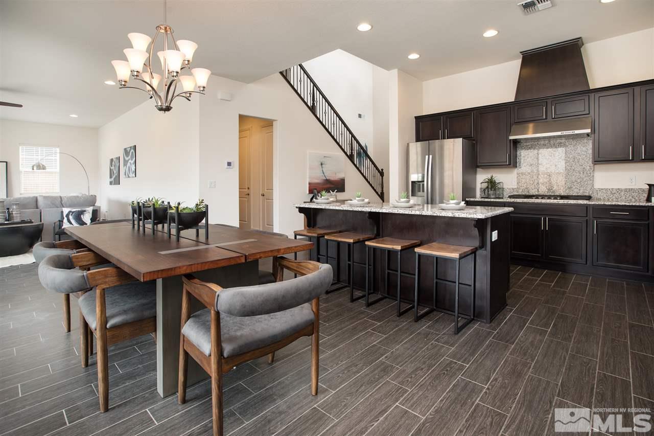 3115 Show Jumper Lane Reno, NV 89521 - Photo 3 of 25 a dining room with wooden floor a chandelier a glass table and chairs