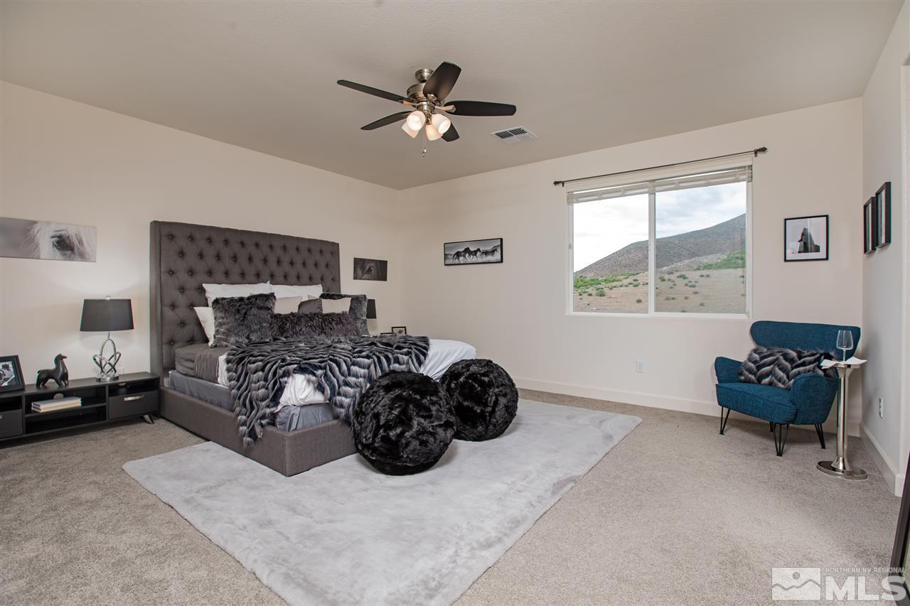3115 Show Jumper Lane Reno, NV 89521 - Photo 7 of 25 a bed room with a bed and a chair
