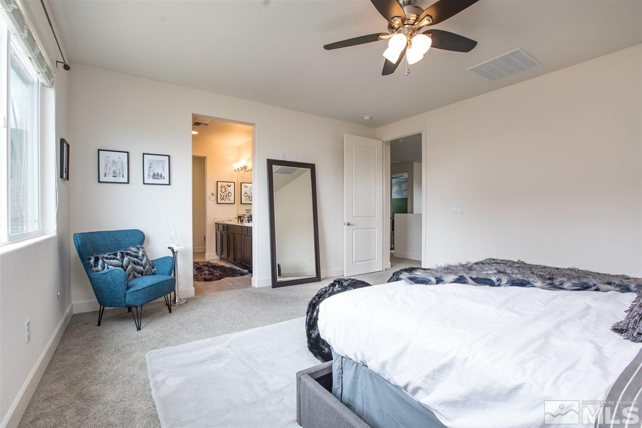 3115 Show Jumper Lane Reno, NV 89521 - Photo 8 of 25 a bedroom with a bed and a chandelier