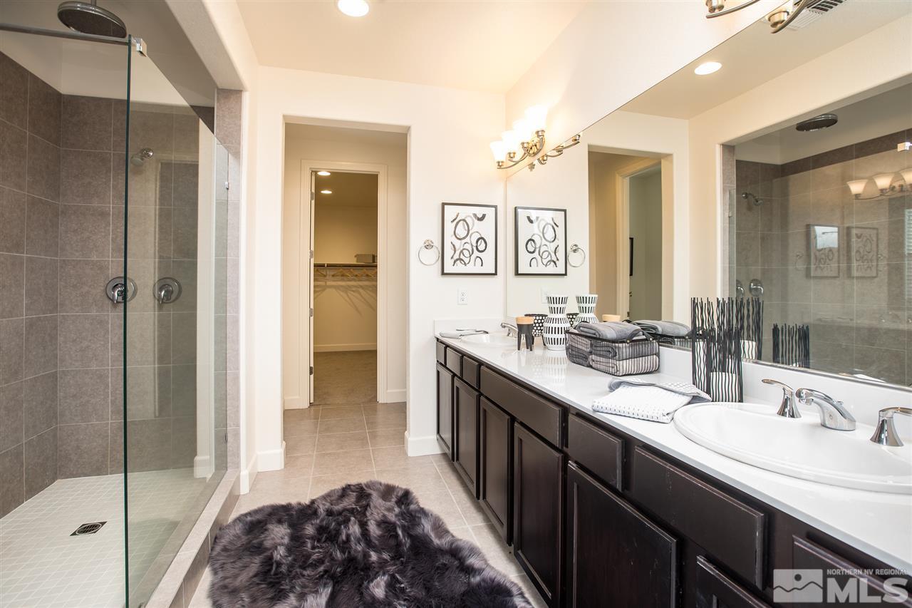 3115 Show Jumper Lane Reno, NV 89521 - Photo 10 of 25 a en suite bathroom with a double vanity sink a mirror and a shower