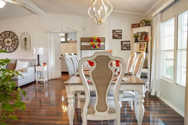 a view of a room with furniture a chandelier and wooden floor