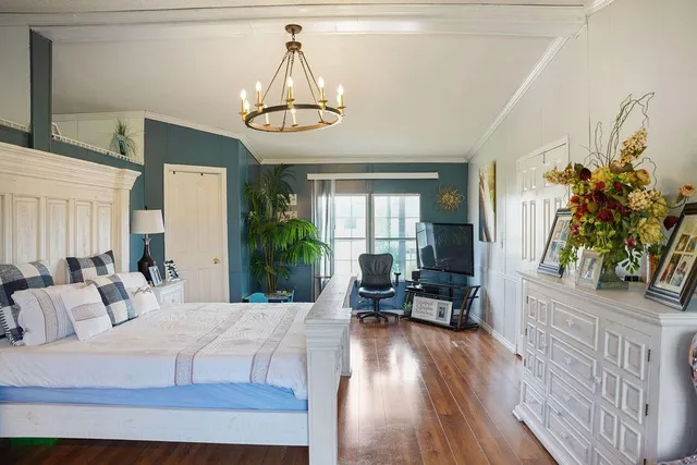 a bedroom with furniture and a wooden floor