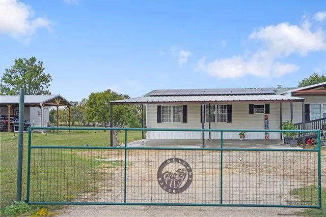 a view of a house with a backyard space