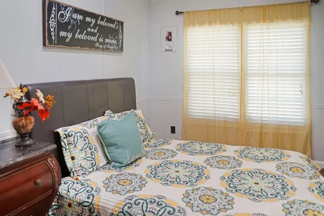 a bedroom with a bed and a couch