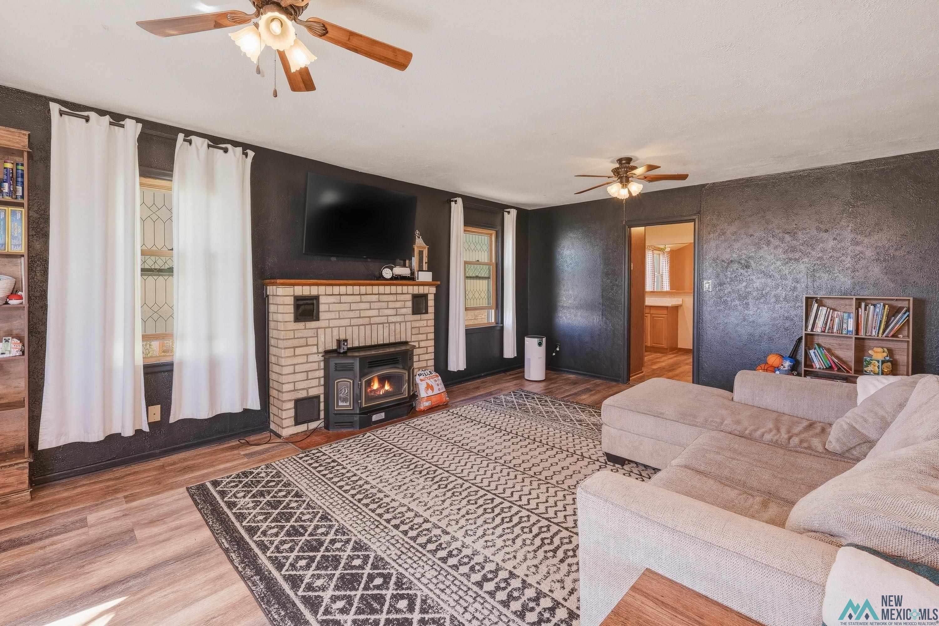 1432 South 5th Street Raton, NM 87740 - Photo 7 of 32 Living area with ceiling fan and wood finished floors