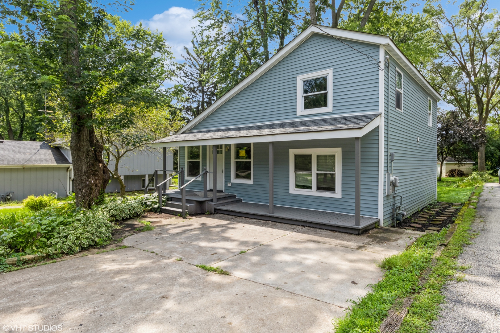 a view of house with a yard and sitting area
