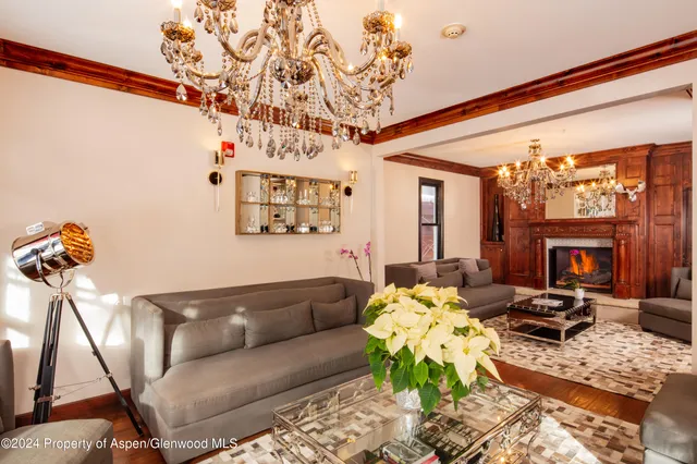 a living room with furniture a fireplace and a table